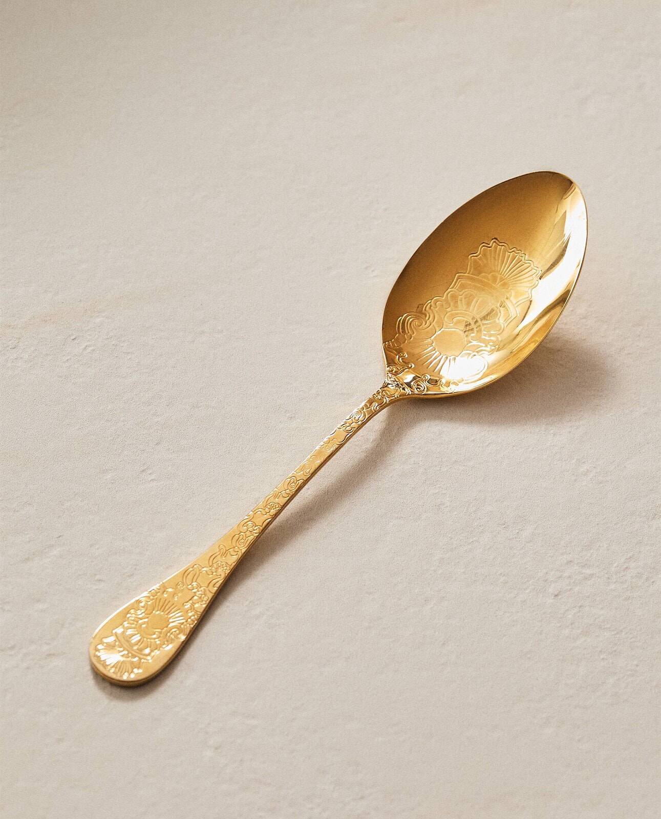 Engraved golden serving spoon