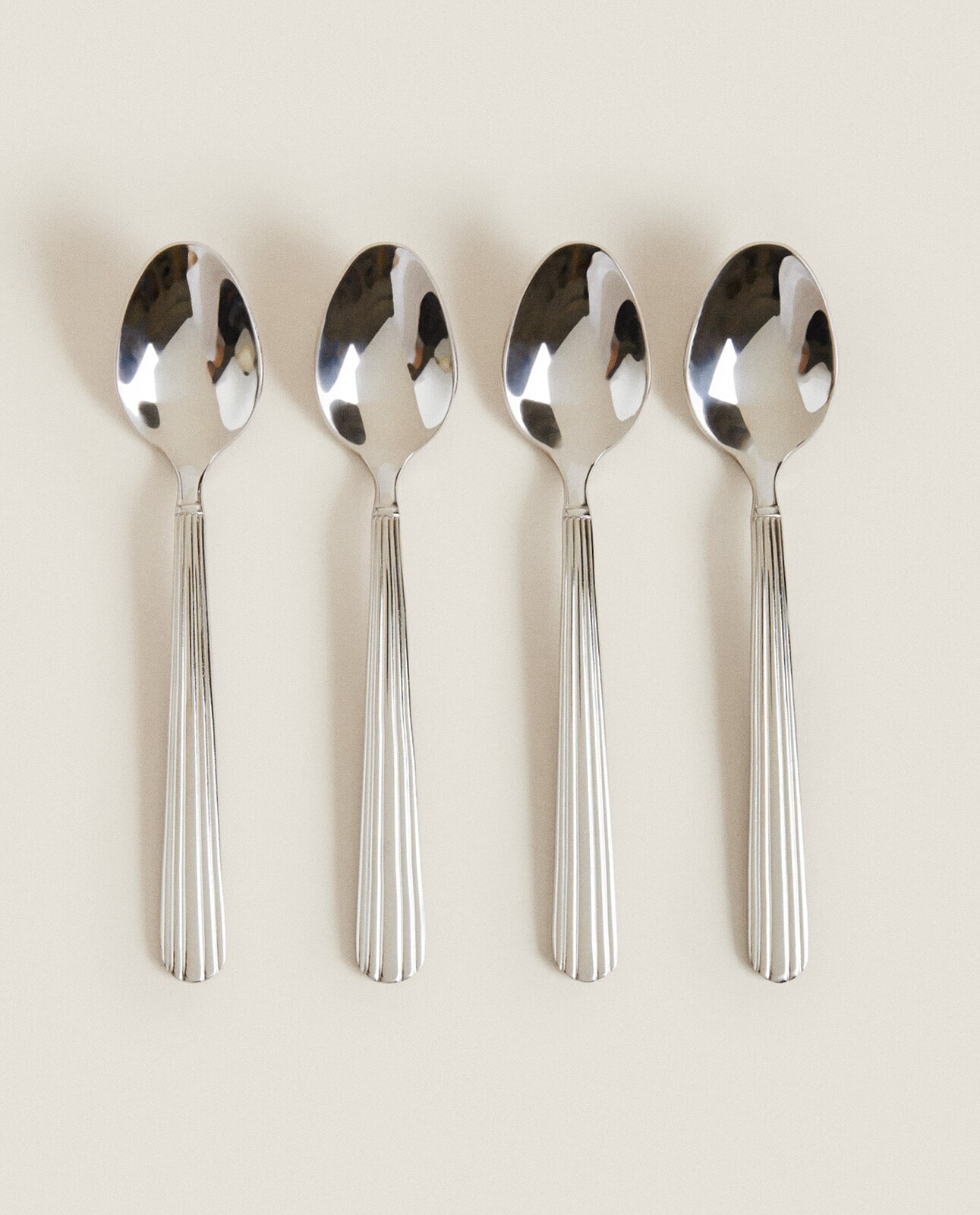 Set of steel dessert spoons with scored handle