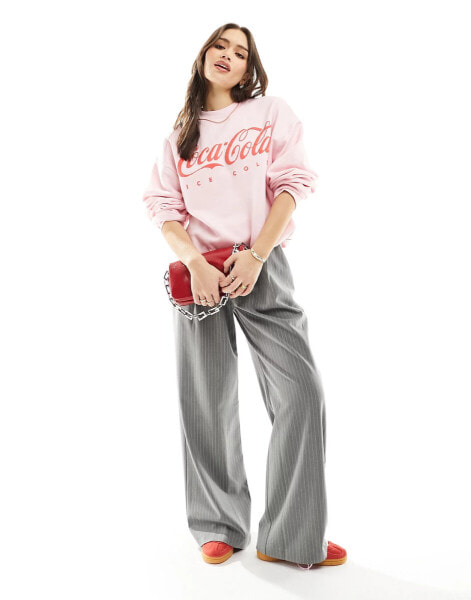 ASOS DESIGN oversized sweat with coca cola licence graphic in pink