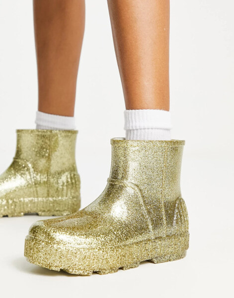 UGG – Drizlita – Gummistiefel in glitzerndem Gold