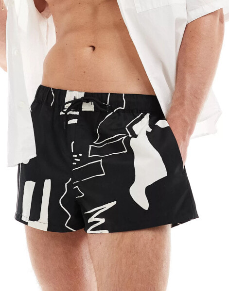 ASOS DESIGN swim shorts in super short length in black print