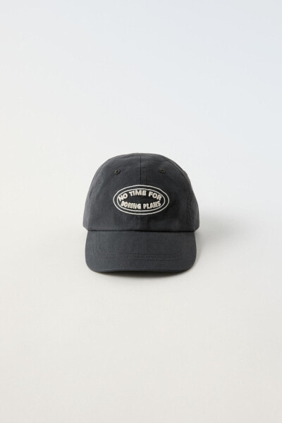 CAP WITH EMBROIDERED SLOGAN