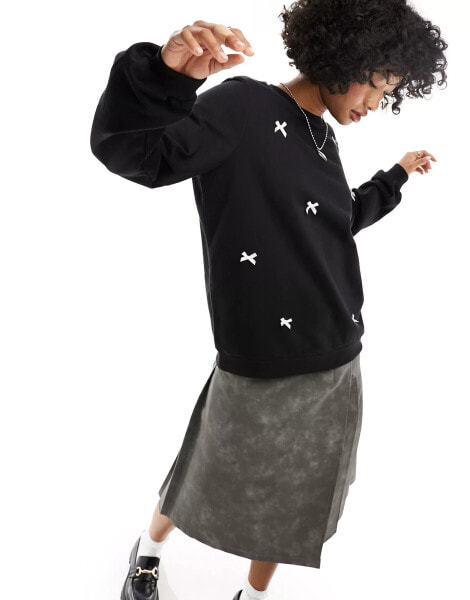 ASOS DESIGN oversized sweatshirt with bows in black