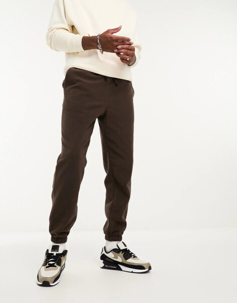 ASOS DESIGN tapered fleece joggers in brown