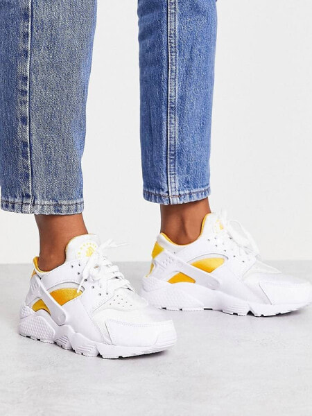 Nike Air Huarache trainers in white and university gold