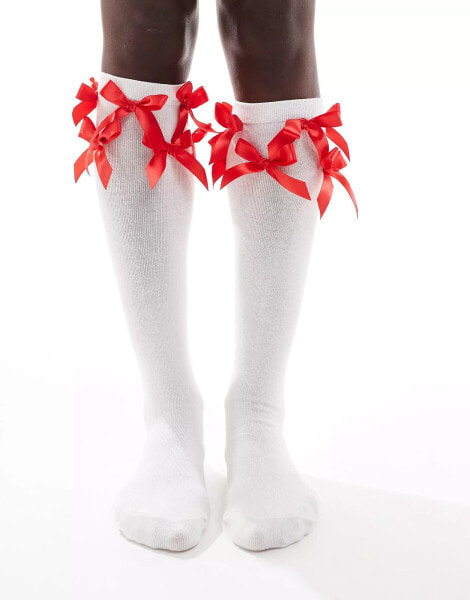 Reclaimed Vintage knee high socks with red bows in white