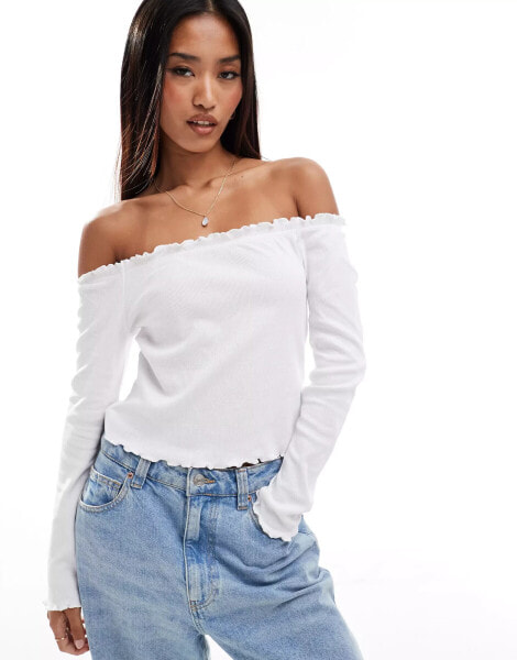 Pieces off the shoulder long sleeved top with lettuce edge detailing in white