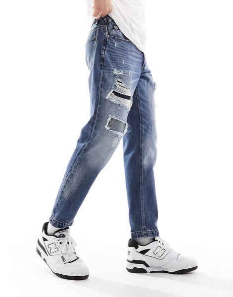 ASOS DESIGN tapered fit jeans with rips in mid wash blue - MBLUE