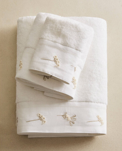 Bath towel with embroidered beaded border