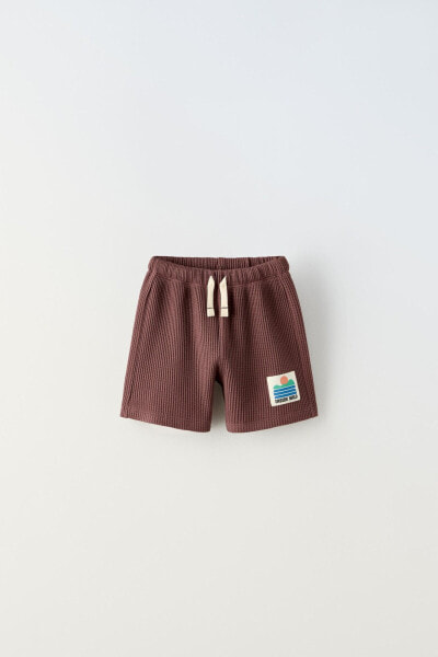 Waffle-knit bermuda shorts with label