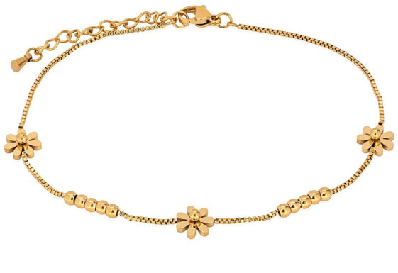 Delicate gilded chain on the leg with flowers