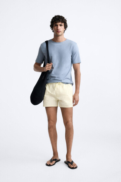 BUTTONED SHORT SWIMMING TRUNKS