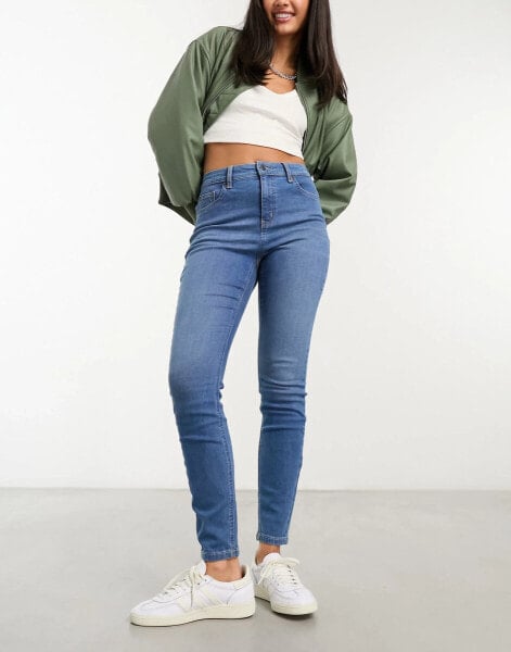 ASOS DESIGN mid rise skinny jean in mid blue