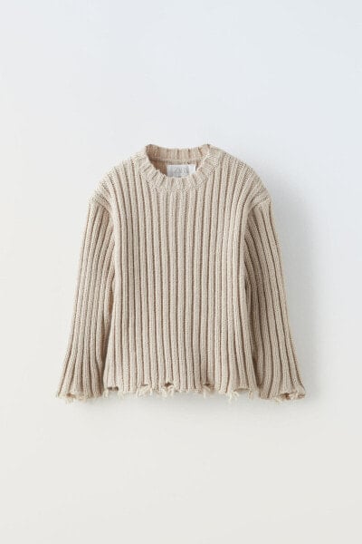 Ribbed sweater with rips