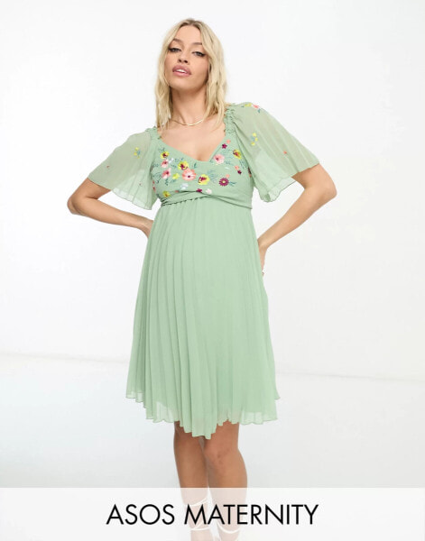 ASOS DESIGN Maternity tie back angel sleeve pleated mini dress with embroidered bust in sage green