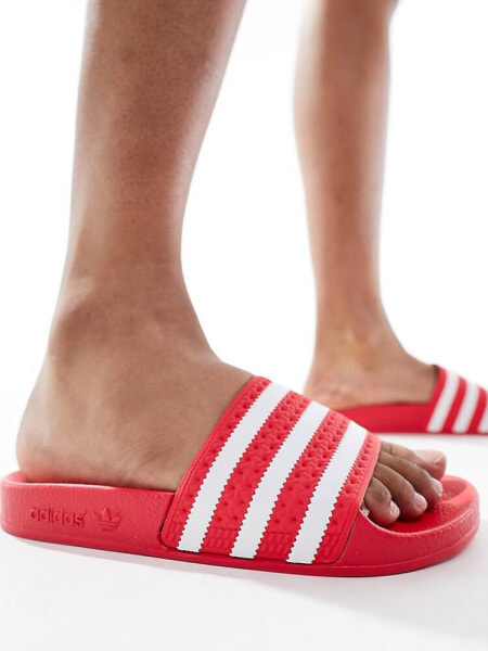 adidas Originals Adilette sliders in coral red