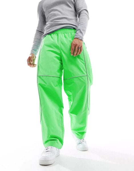 The North Face Tek woven joggers with reflective piping in bright green