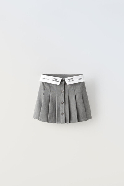 Box pleat skirt with slogan waistband