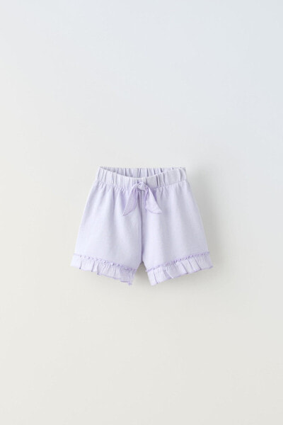 Plush bermuda shorts with bow and ruffles