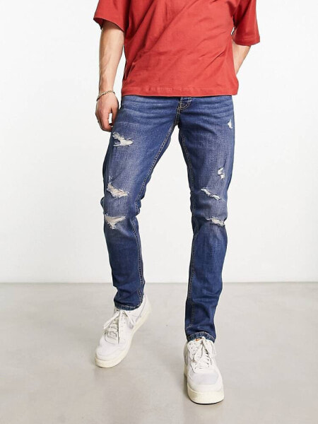 Jack & Jones Intelligence – Glenn – Schmal geschnittene Jeans in verwaschenem Mittelblau mit Abnutzungen