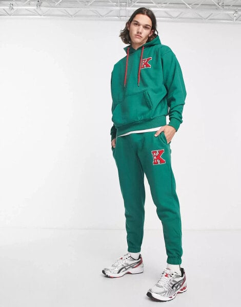 Karl Kani retro patch joggers in green