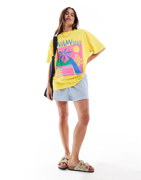 ASOS DESIGN oversized t-shirt with miami beach graphic in yellow