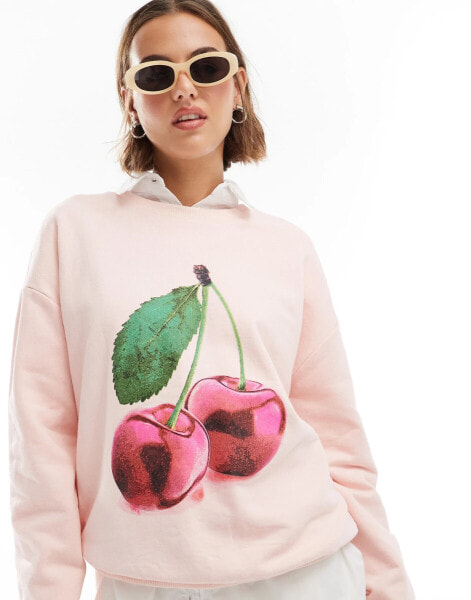 ASOS DESIGN oversized sweatshirt with cherry graphic in baby pink