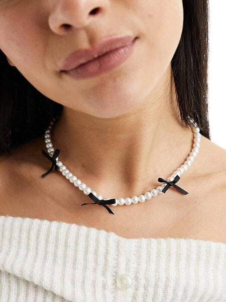 ASOS DESIGN necklace with faux pearl and black bow detail