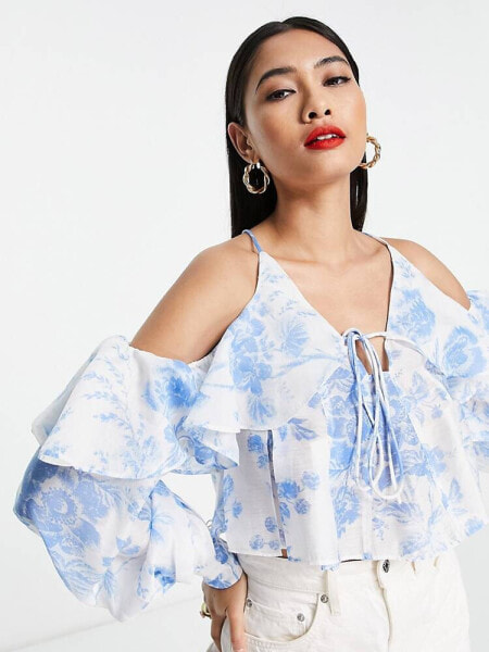 ASOS DESIGN ruffle blouse with lace up back in blue floral 