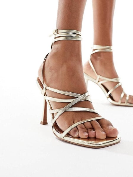 ASOS DESIGN Native strappy heeled sandals in gold