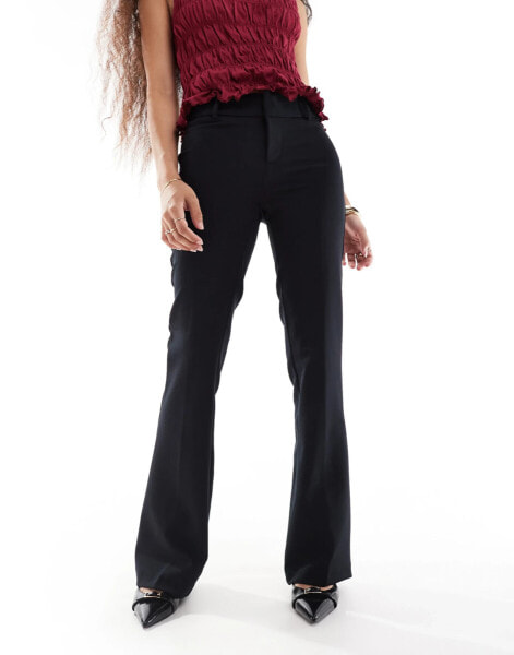 Bershka Petite flared tailored trousers in black