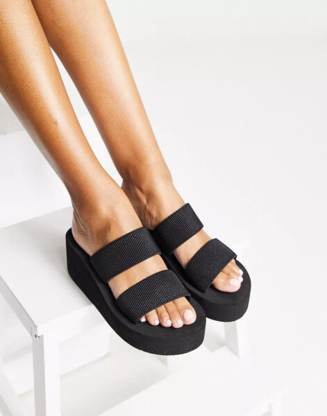 Truffle Collection – Mule-Sandalen in Schwarz mit flacher Plateausohle