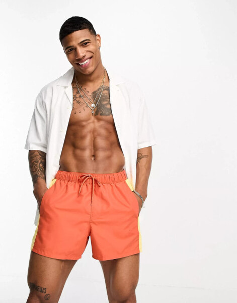 ASOS DESIGN swim shorts in short length in orange