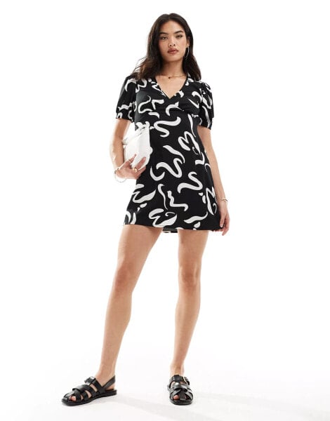 Wednesday's Girl v-neck short sleeve mini dress in black and white swirl