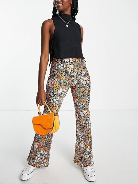 Monki Ocean plisse flare trousers in rainbow floral