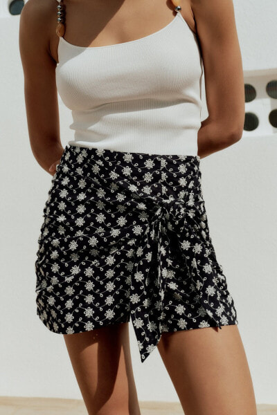 Knotted skort with cutwork embroidery