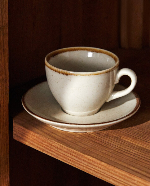 Porcelain teacup with antique finish rim