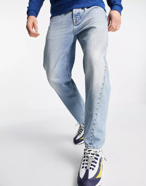 Topman tapered curved leg jeans in light wash blue