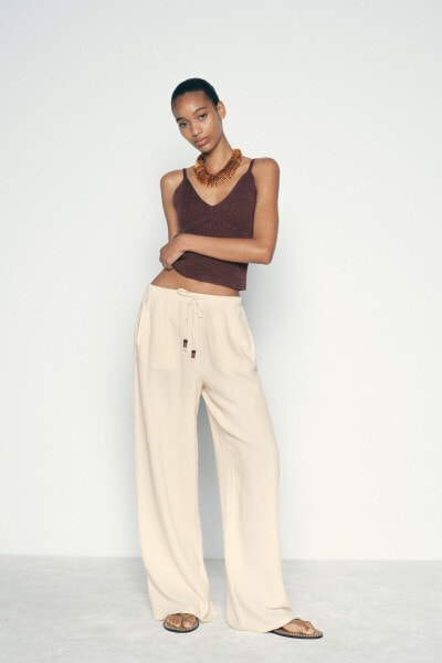 CREASED-EFFECT WIDE-LEG TROUSERS