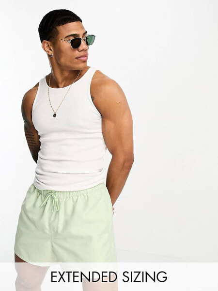 ASOS DESIGN swim shorts in short length in light green