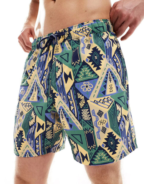 ASOS DESIGN swim shorts in mid length in abstract print in blue