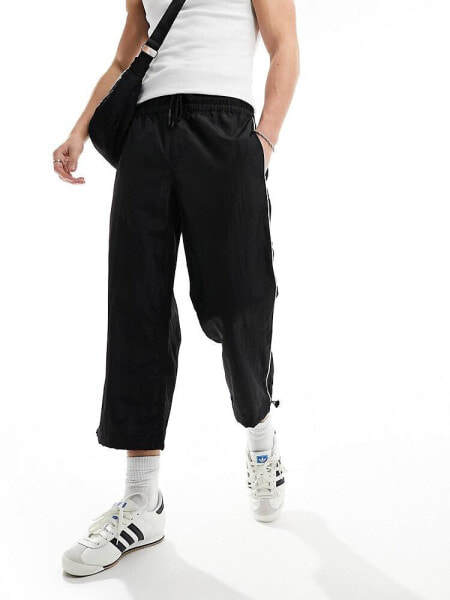 ASOS DESIGN wide awkward length nylon trouser with toggle detail in black