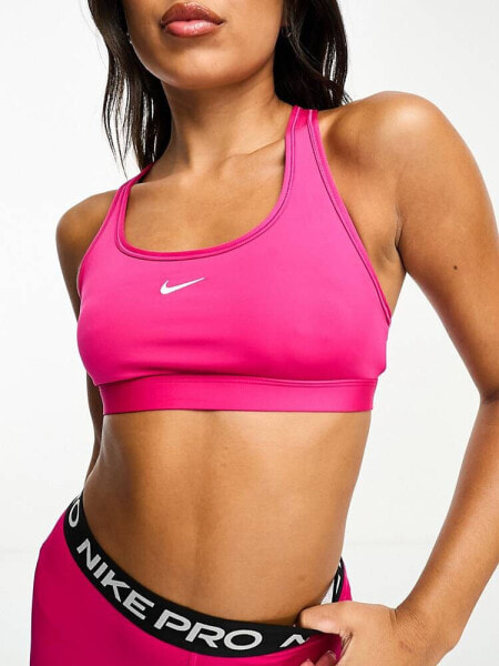 Nike Training Swoosh Dri-Fit light support bra in fireberry pink