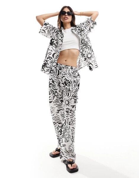 IIsla & bird graphic print loose fit beach trouser co-ord in white and black