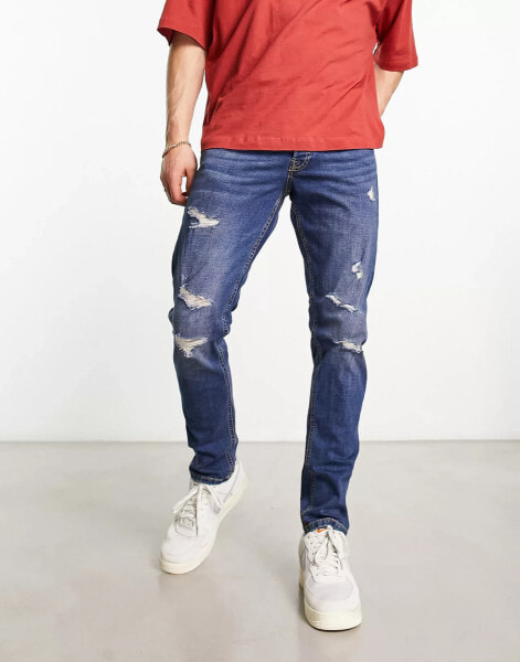 Jack & Jones Intelligence – Glenn – Schmal geschnittene Jeans in verwaschenem Mittelblau mit Abnutzungen