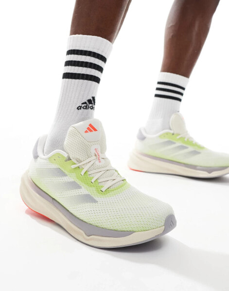 adidas Running Supernova Stride trainers in off white and lime