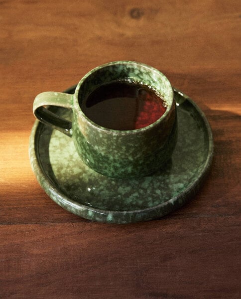 Green stoneware coffee cup and saucer