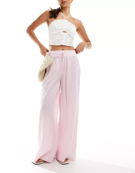 Bershka tie waist seersucker wide leg trousers in pink & white stripe