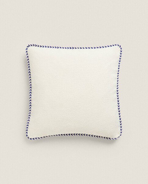Woven cushion cover with trim