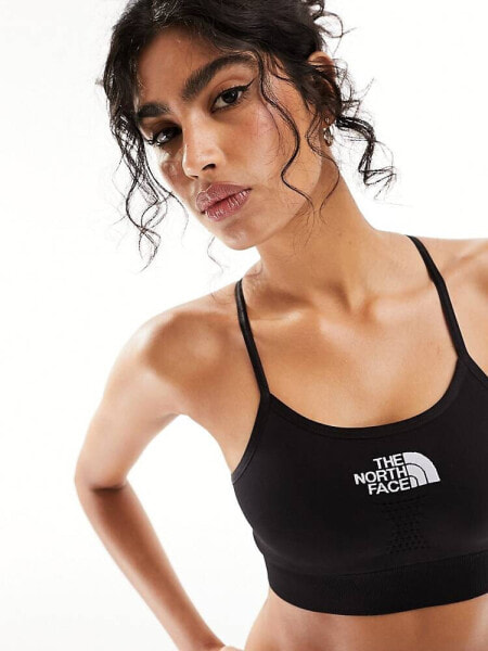 The North Face Training seamless performance sports bra in black Exclusive at ASOS